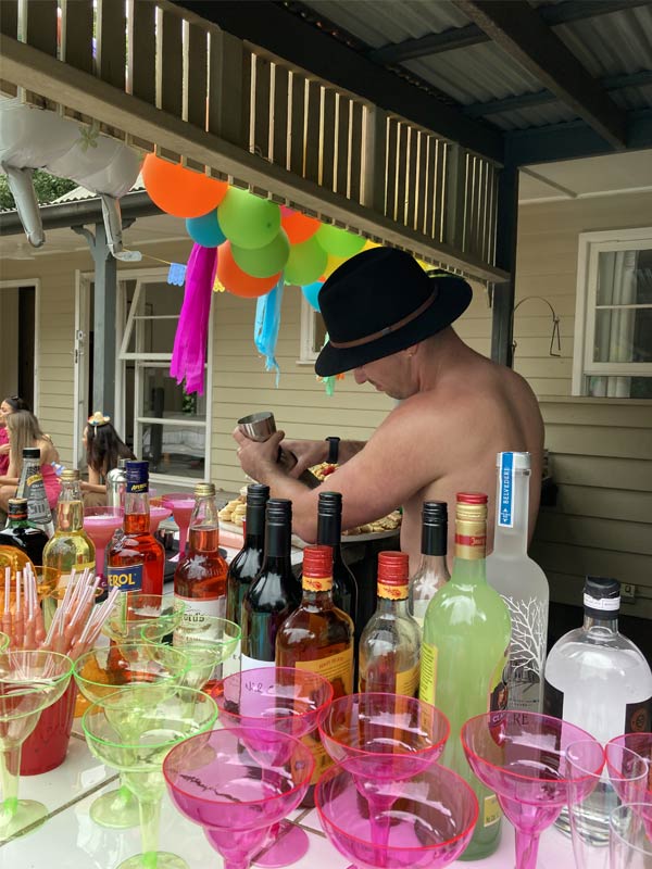 Hen's party topless waiter serves from a private bar in Wollongong Airbnb